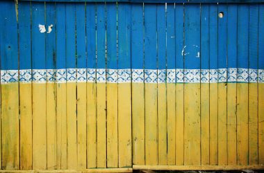 A fence painted the colours of the Ukrainian flag